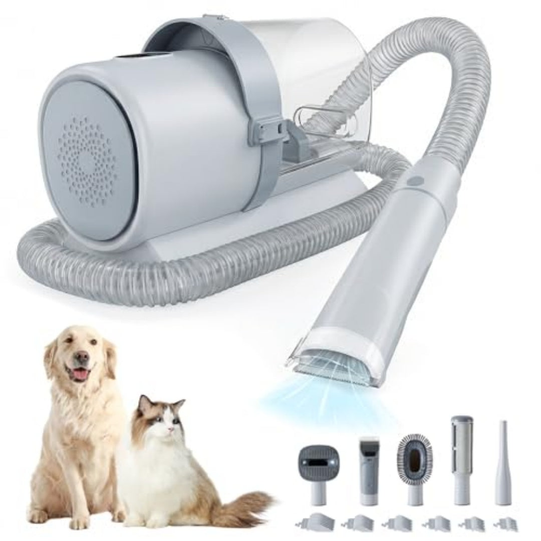 Pet grooming vacuum with hose, attachments and guide combs beside a dog and cat