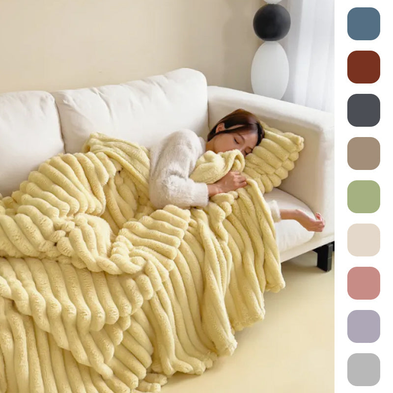 Yellow bubble-textured blanket on a white sofa with color swatches